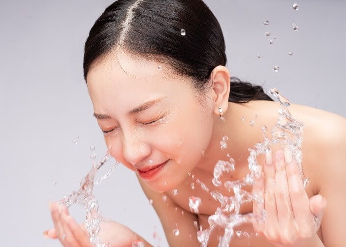 Beautiful Asian woman washes h